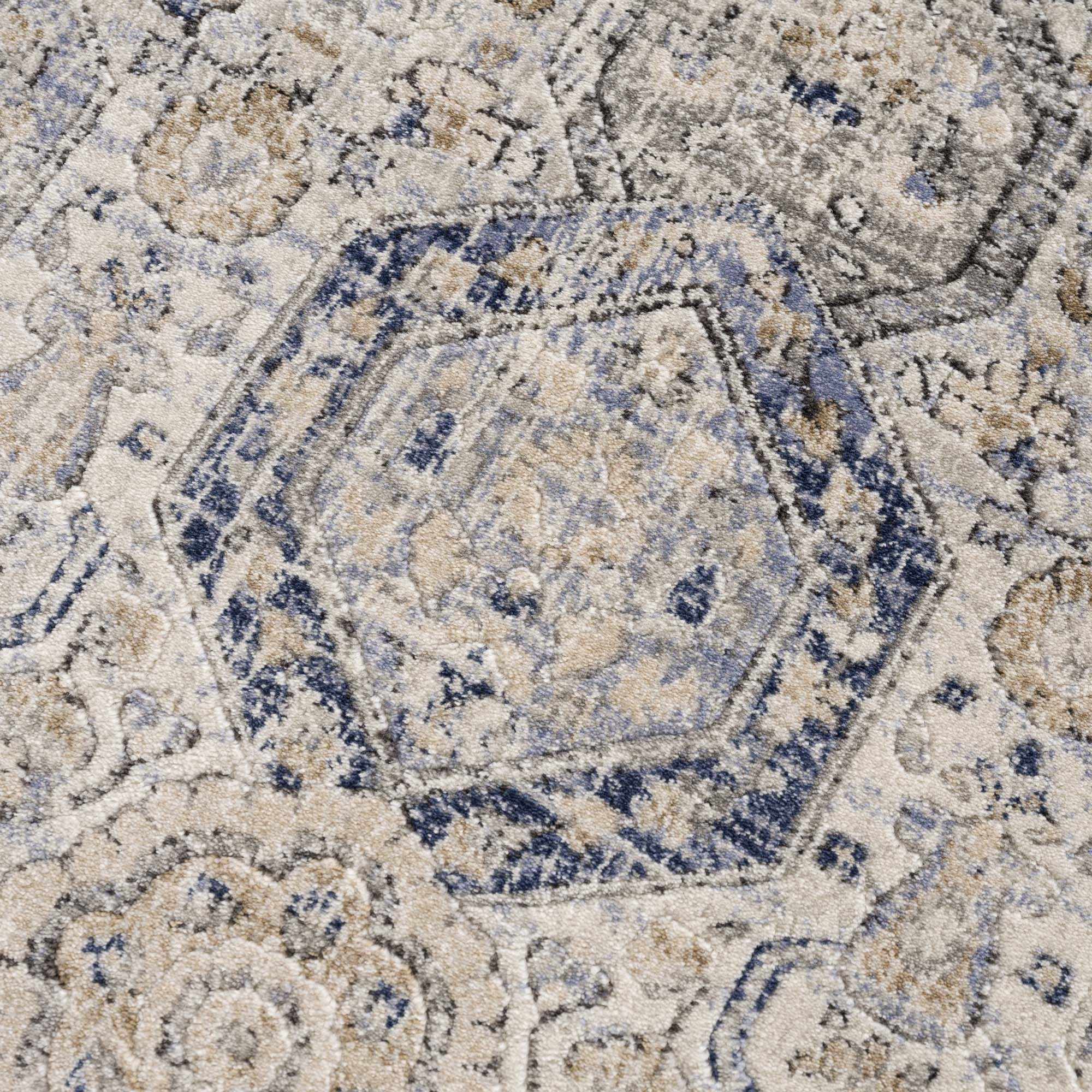 Close-up of Parkerfield Area Rug's hexagonal motif in navy and beige. Intricate traditional design enhances any room¡¯s decor.