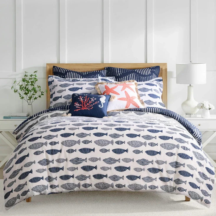 Bakio Duvet Cover - Nautical Theme features a reversible cotton quilt set with navy fish patterns and coastal accent pillows on a king bed.