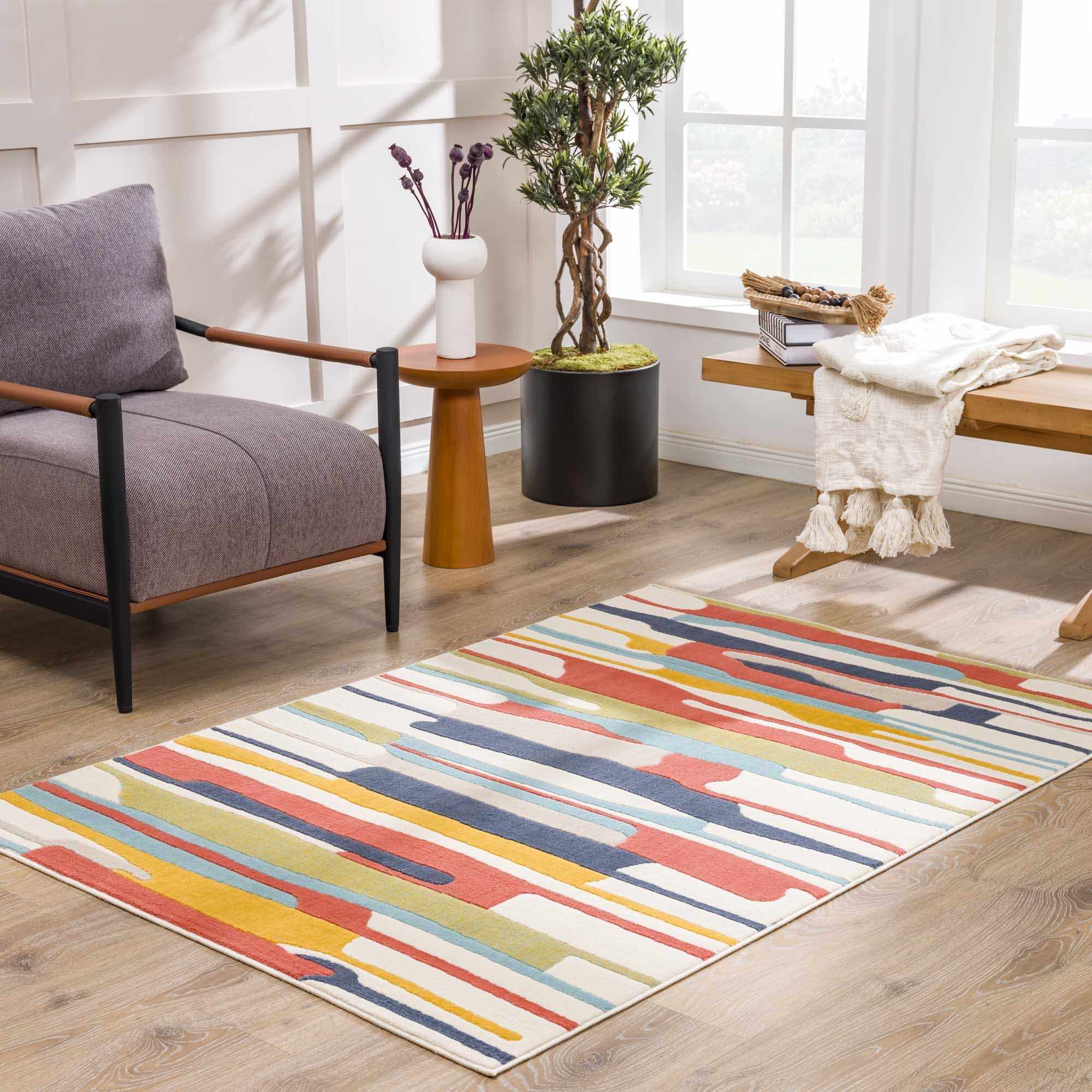 Southfields Area Carpet - Modern Design in a bright sitting area with wood floors and large windows for natural light.