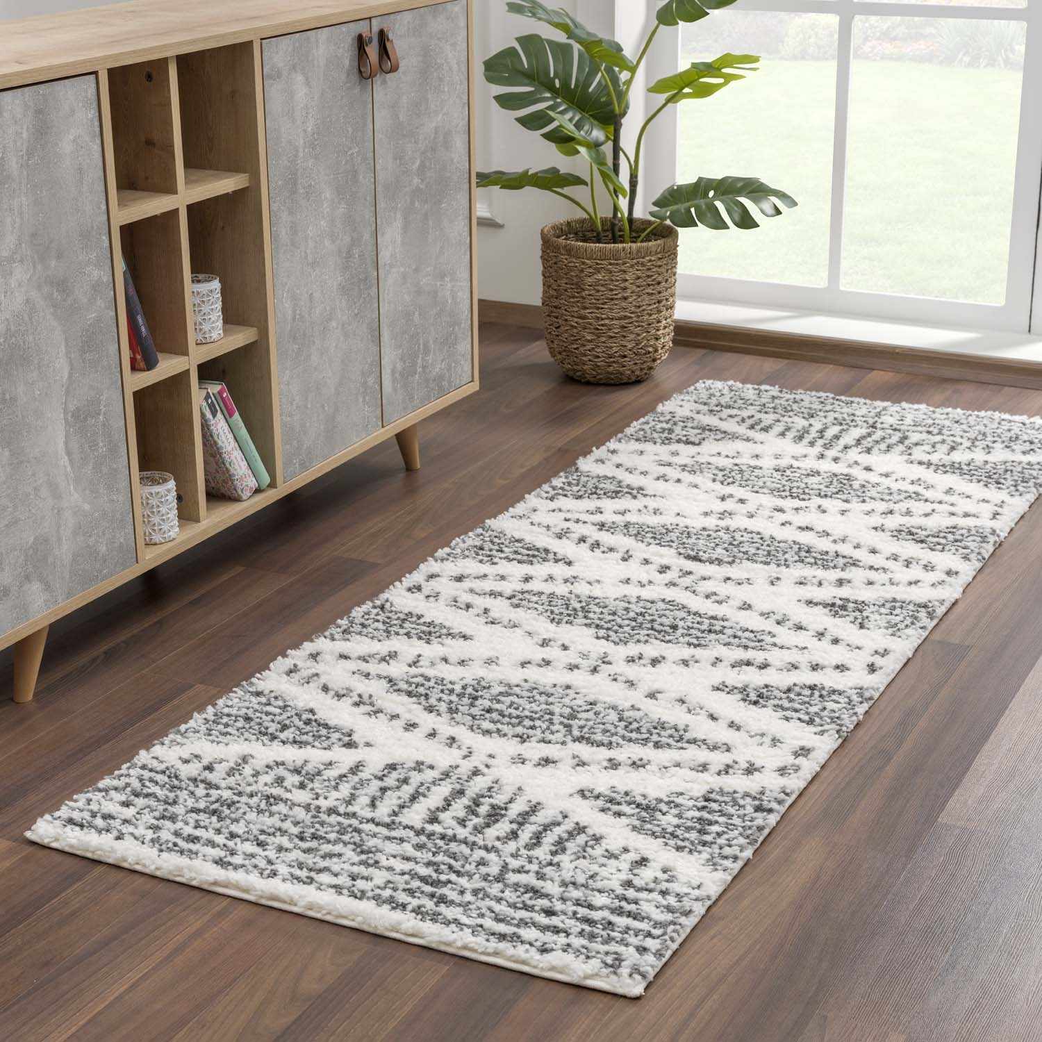 "Trunding Plush Area Rug runner in front of a cabinet, showcasing its machine-woven texture and transitional design."