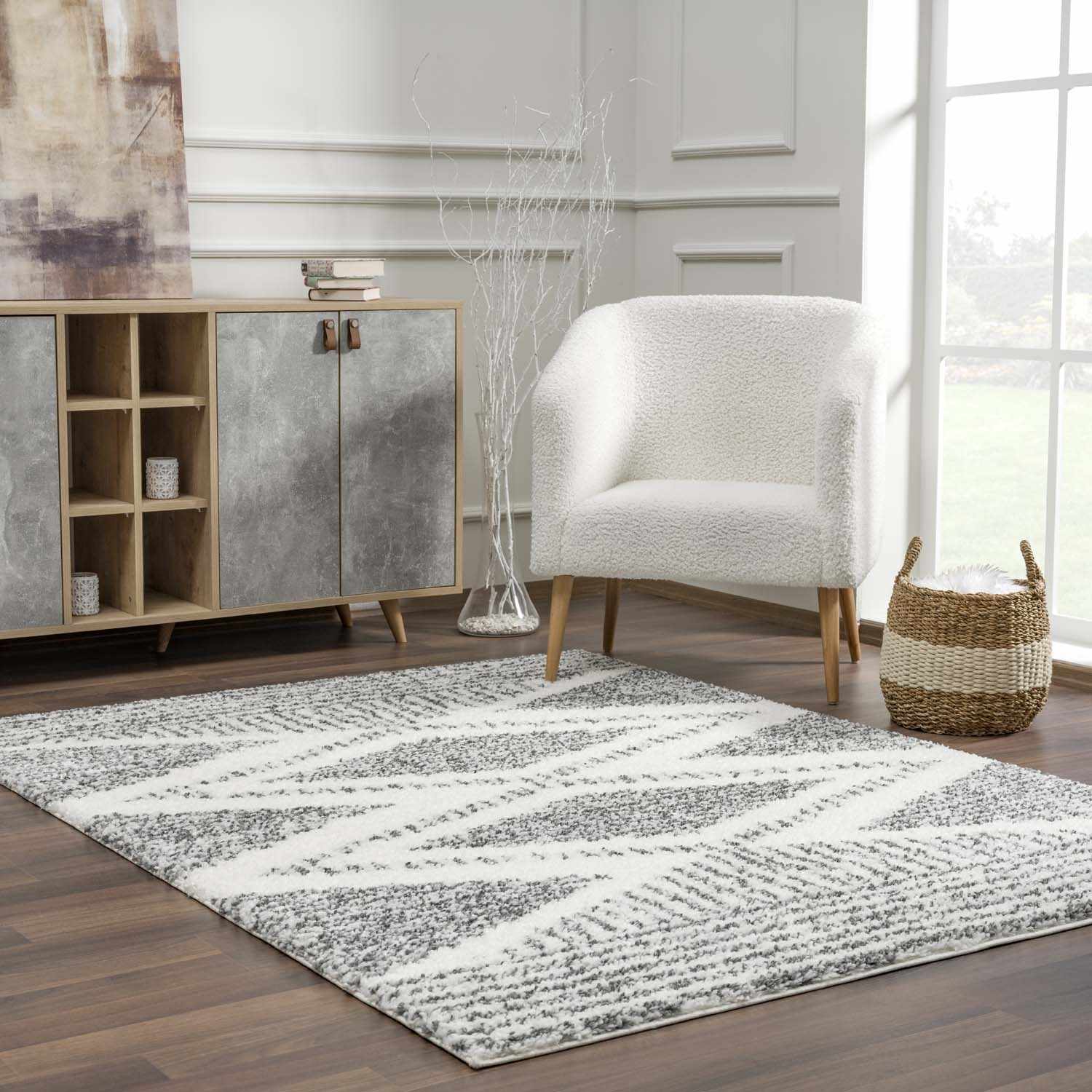 "Trunding Plush Area Rug in a modern sitting area with white armchair and wood flooring, blending comfort with style."