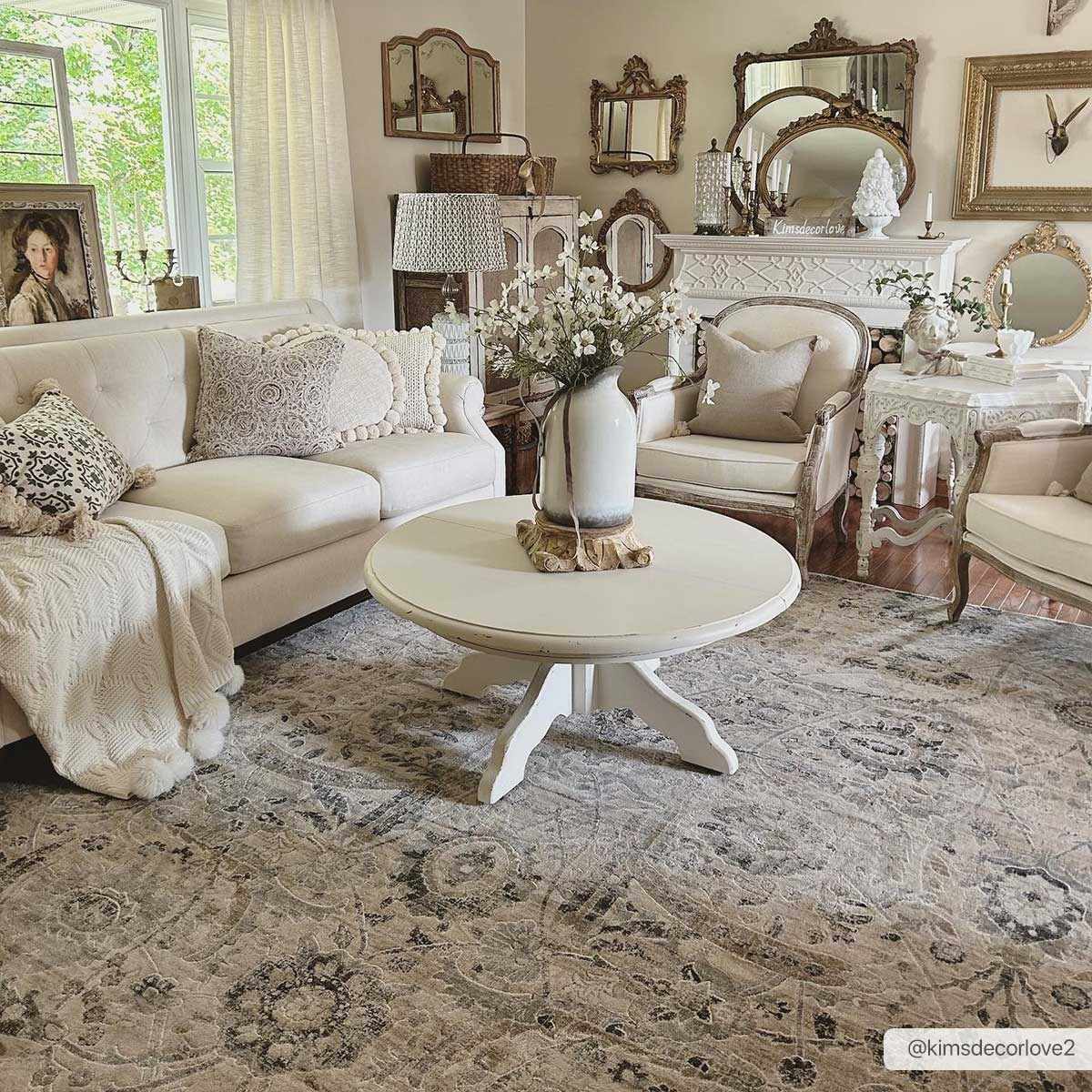 Georgiana Beige Area Rug - Stylish Floor Decor styled in a vintage-inspired living room with neutral decor and floral arrangements.