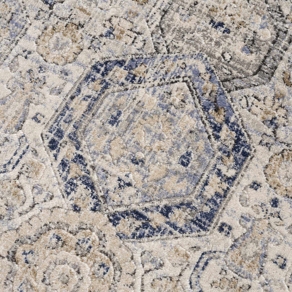 Close-up of Parkerfield Area Rug's hexagonal motif in navy and beige. Intricate traditional design enhances any room¡¯s decor.