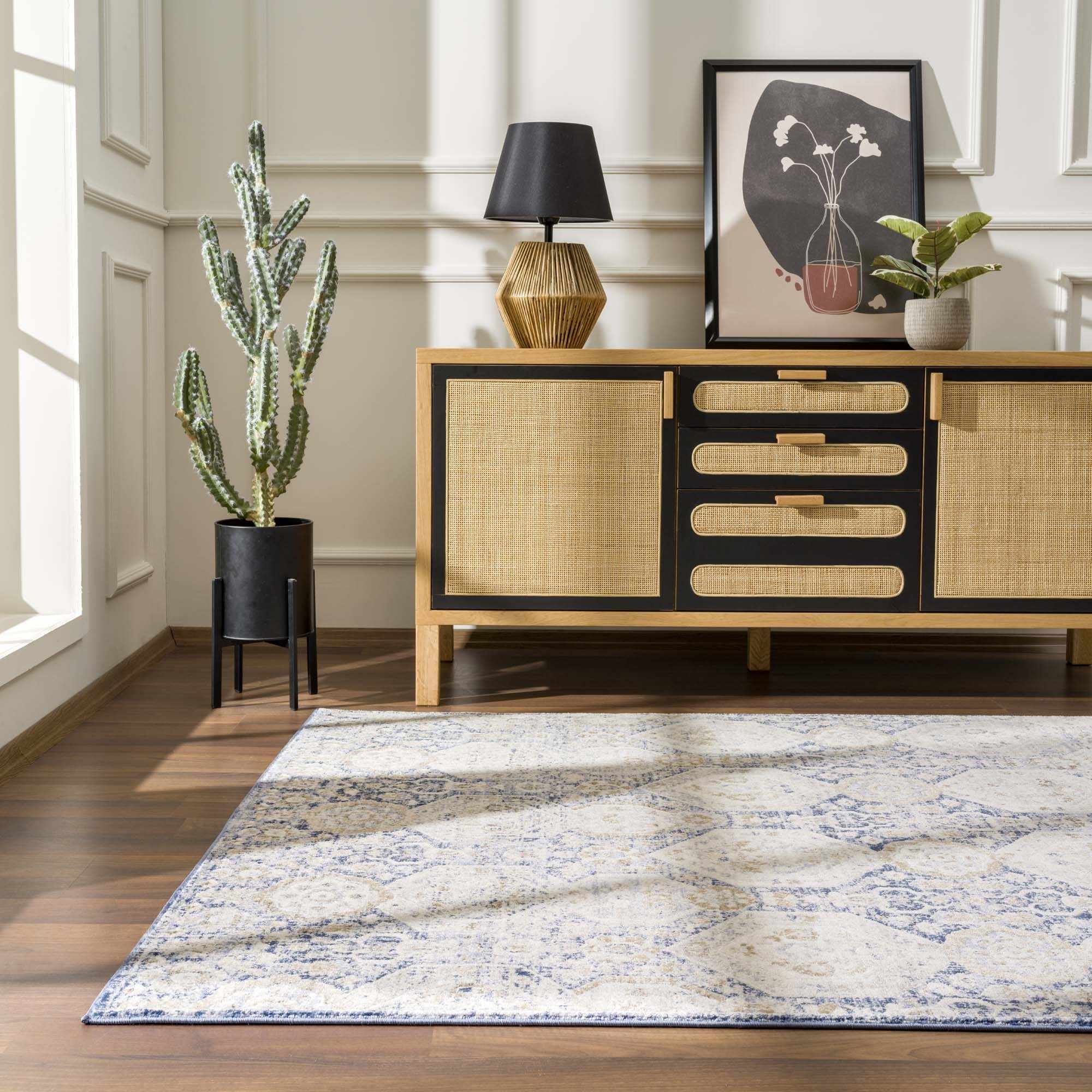 Bright room featuring Parkerfield Blue Area Rug with navy and beige tones. Enhances decor with traditional pattern and medium pile.