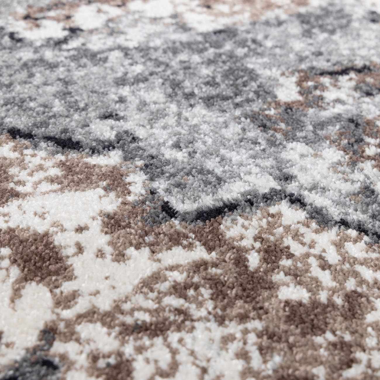 "Close-up of Newalla Area Rug texture, highlighting its soft medium pile and detailed machine-woven polypropylene fibers in neutral tones."