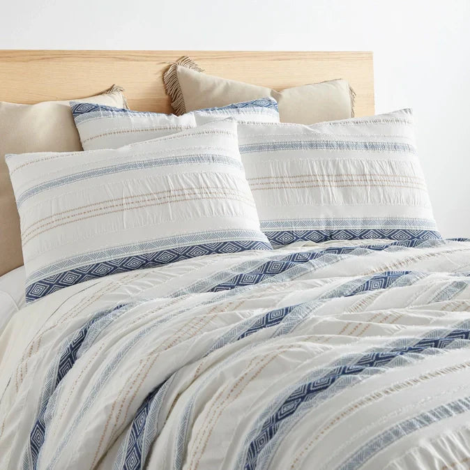 "Pickford Cotton Comforter Set in blue and white with jacquard tribal pattern, shown on a bed with matching pillow shams. Durable cotton bedding."