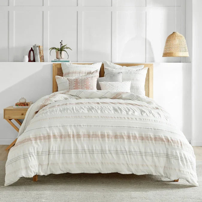 Pickford 100% Cotton Duvet Set in blush with jacquard pattern on a coastal-style bed. Durable and breathable bedding for modern beach-themed bedrooms.