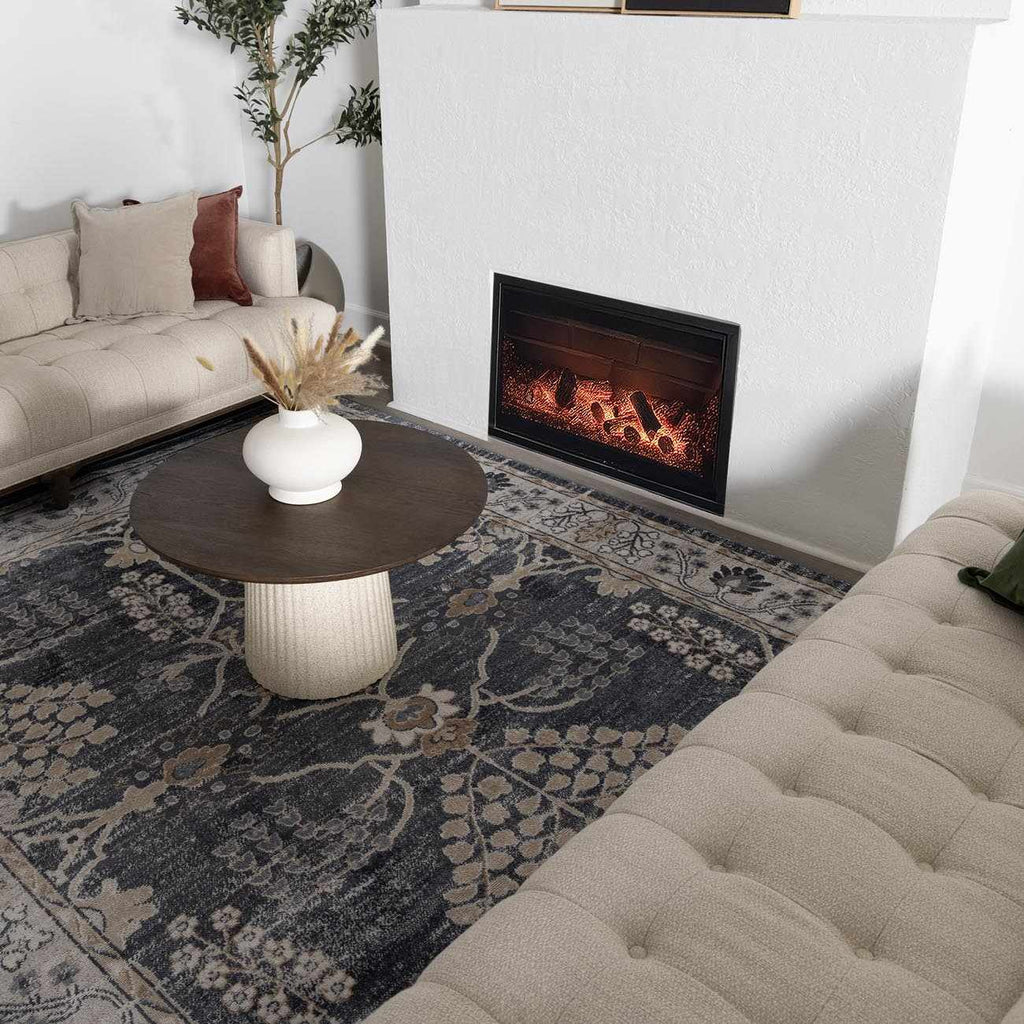 Scalby Area Rug - Traditional | Hauteloom Styles under round coffee table in a stylish living room with fireplace.