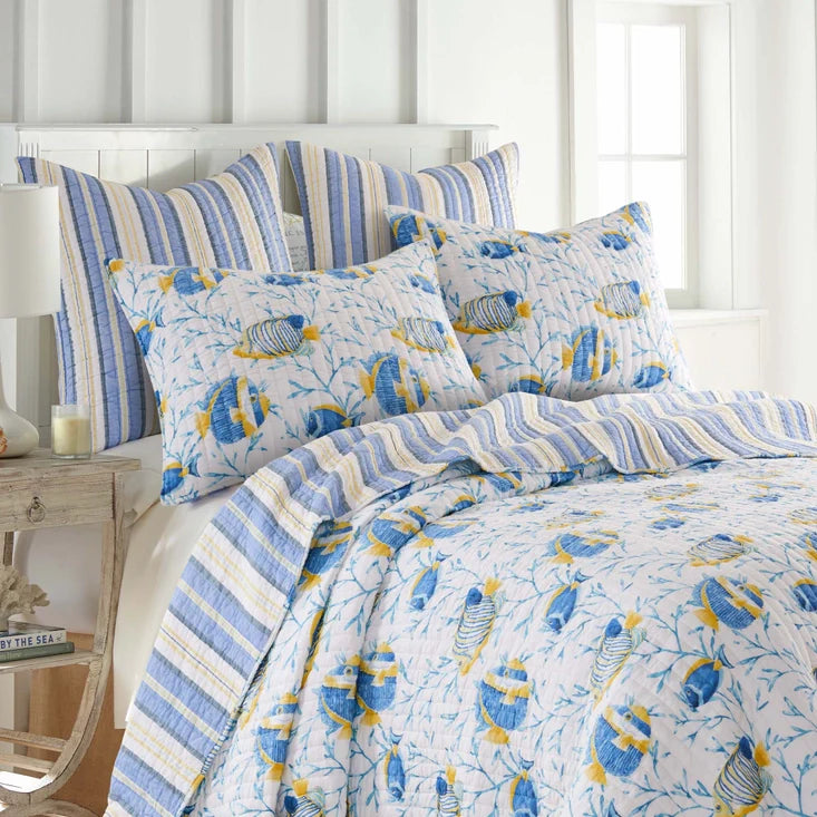 "Tropical Sea Quilt Set with fish-themed design in blue and yellow on a white background, reversible to striped pattern, 100% cotton bedding."