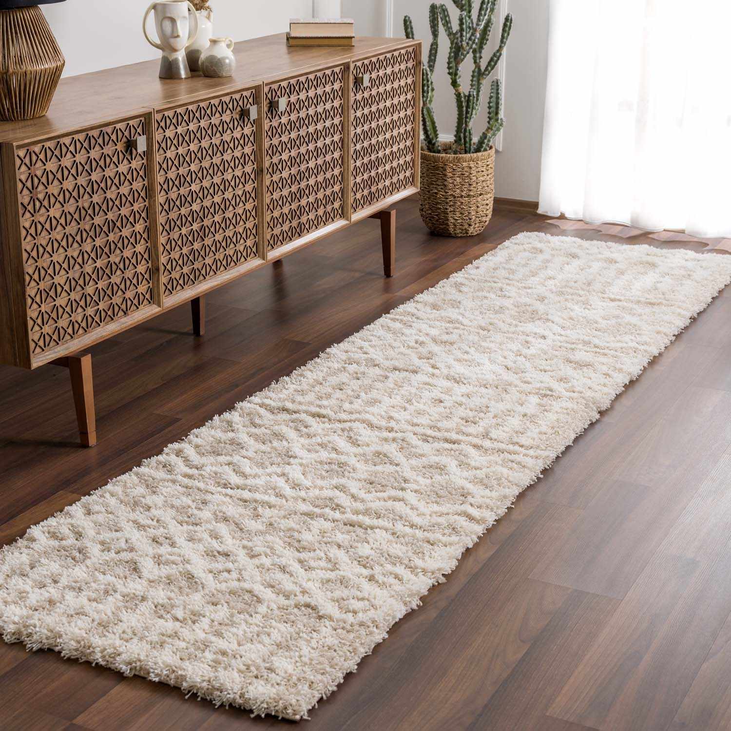 "Prompton Cream Plush Area Rug runner in hallway with wood floor, perfect for narrow spaces in home decor."