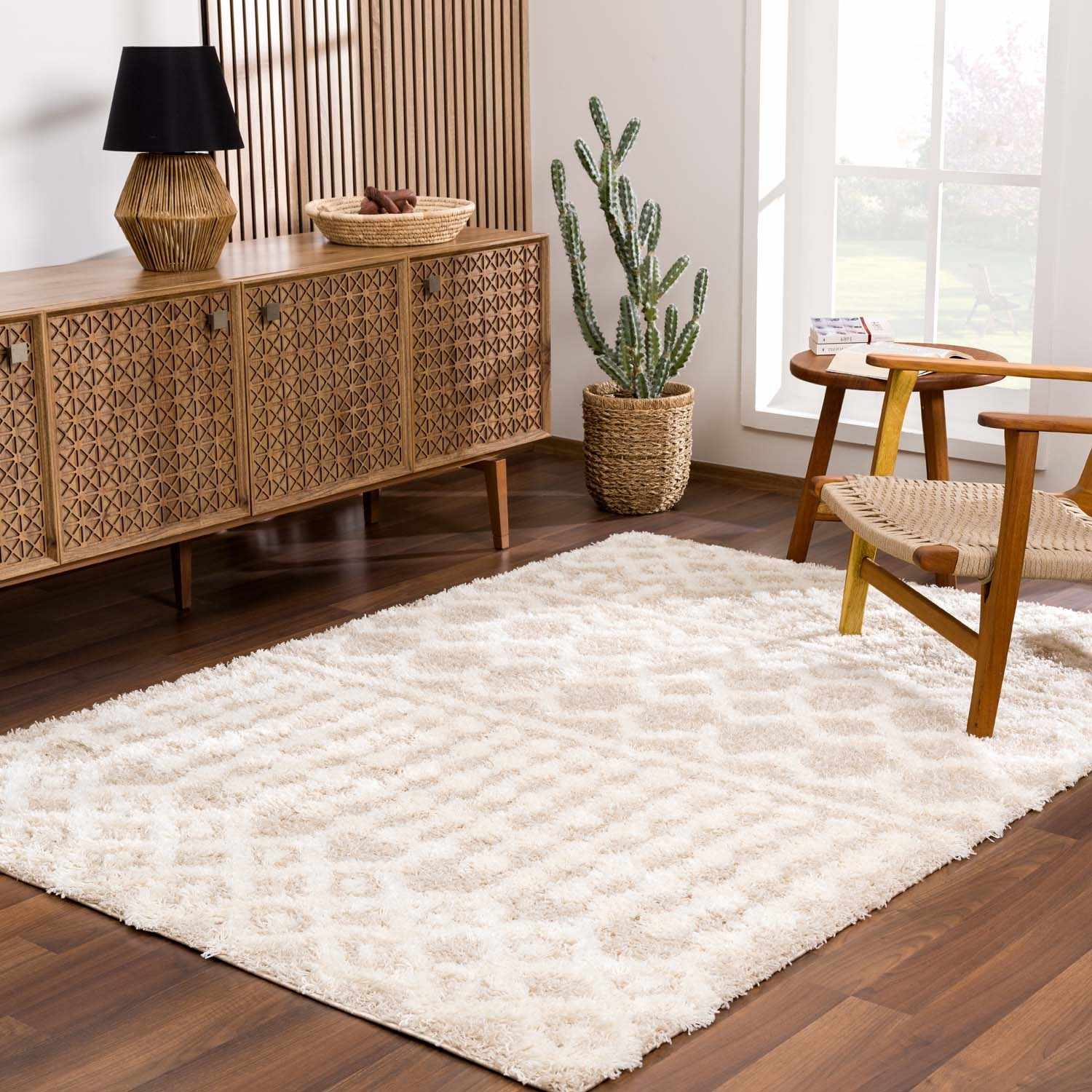 "Prompton Cream Plush Area Rug in modern living room with natural wood tones, ideal for cozy and stylish home flooring."