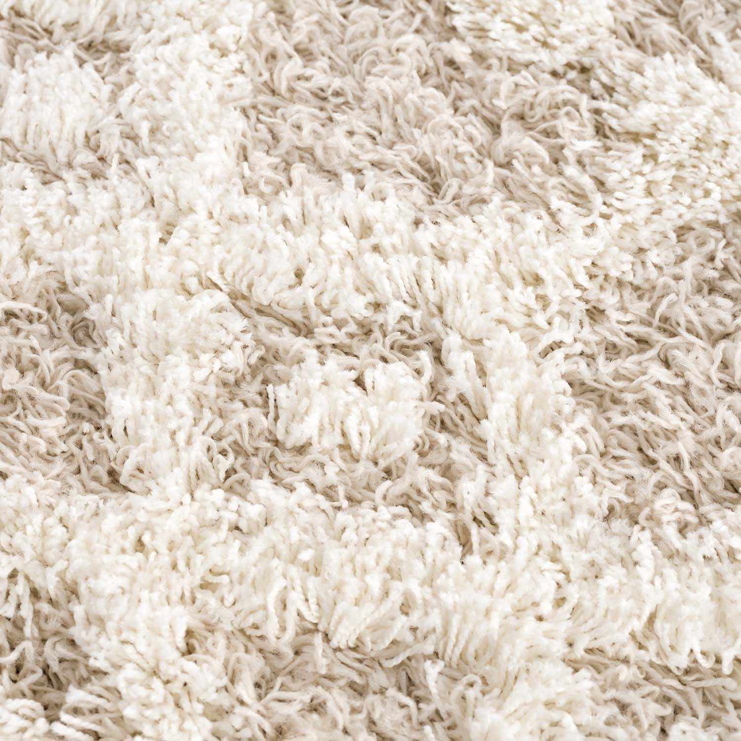 "Detailed texture of Prompton Cream Plush Area Rug with cream and beige tones, perfect for Bohemian-inspired home decor."
