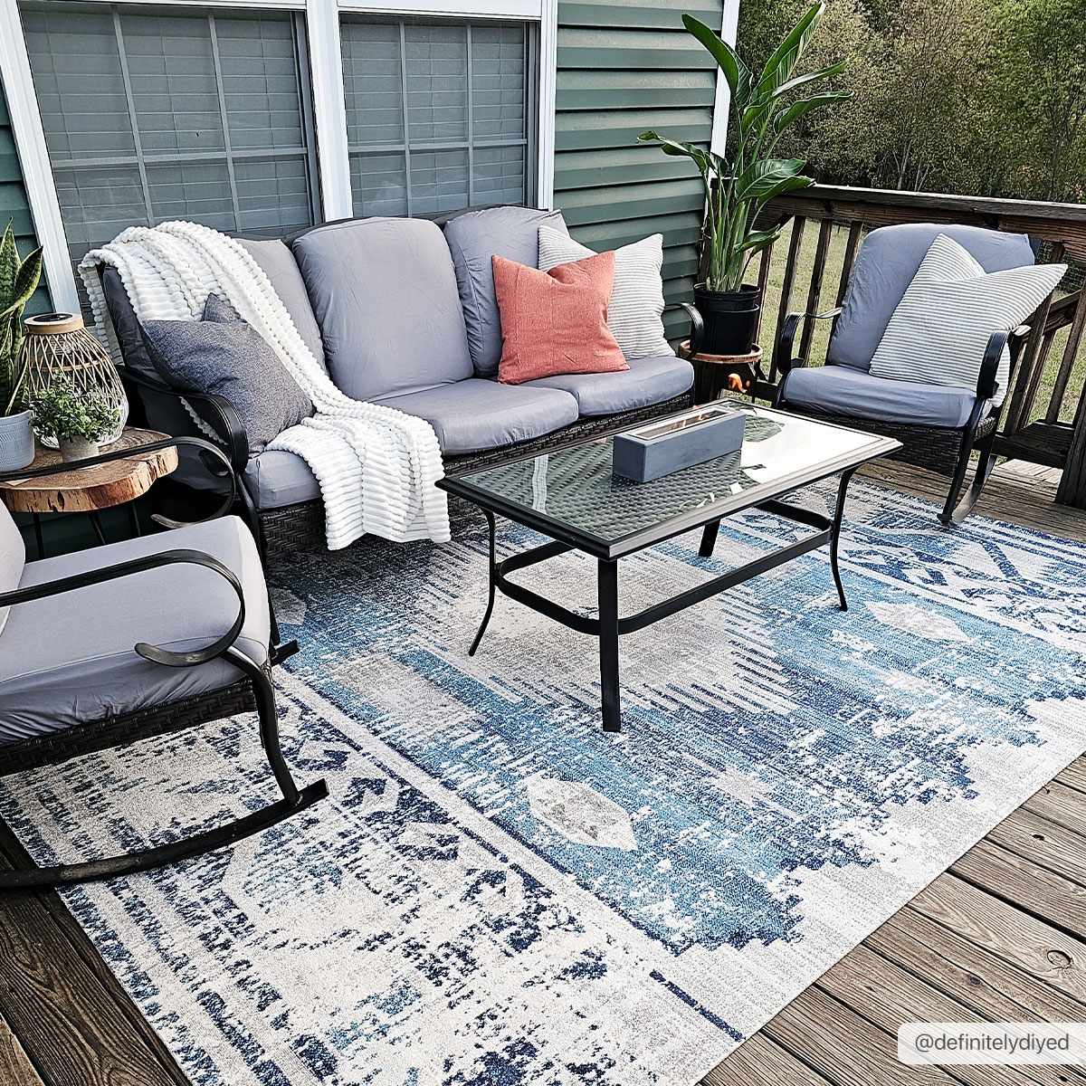 Westmount Denim Aztec Rug - Low Pile styled on a patio with outdoor seating. Ideal for transitional and bohemian outdoor decor.