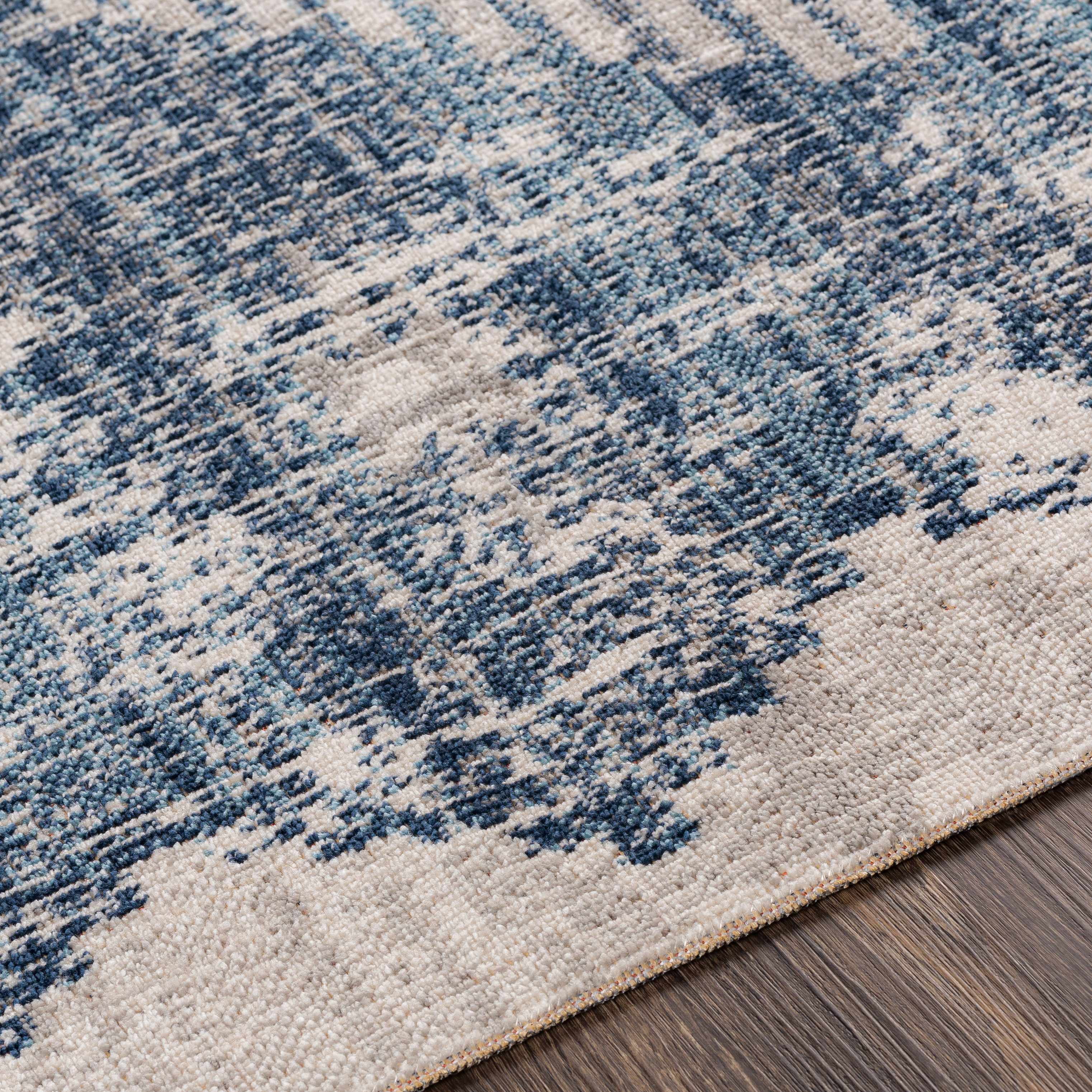 Corner view of Westmount Denim Aztec Rug - Low Pile highlighting texture and low-pile surface. Perfect for high-traffic areas.